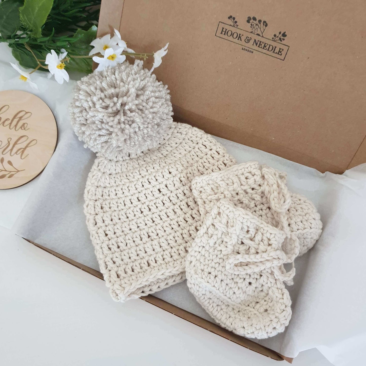 Baby Hat & Laced Boots Set - Cream in a gift box, showcasing a crochet hat with pompom and matching boots.
