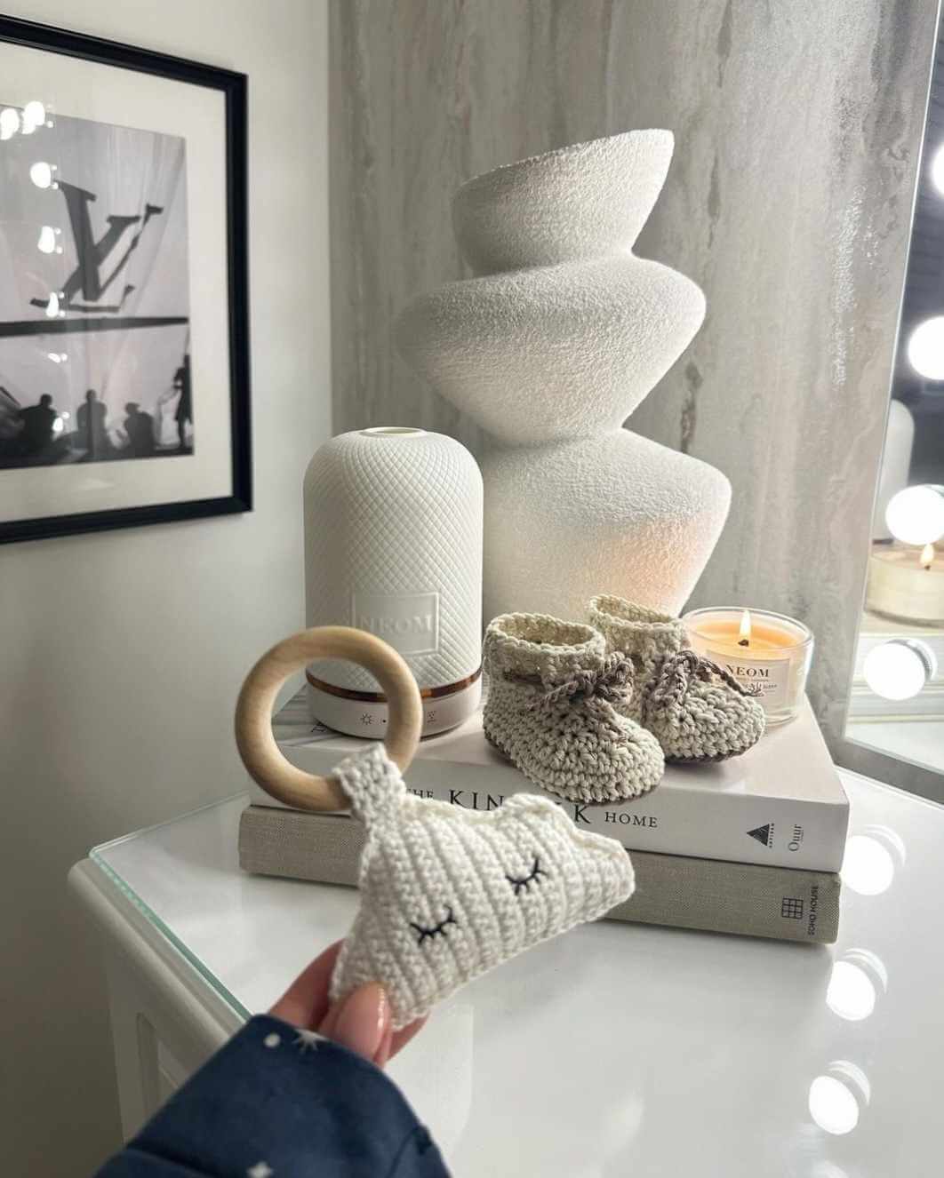 Cotton baby boots - Brown/Cream displayed with a decorative lamp and items on a stylish table.