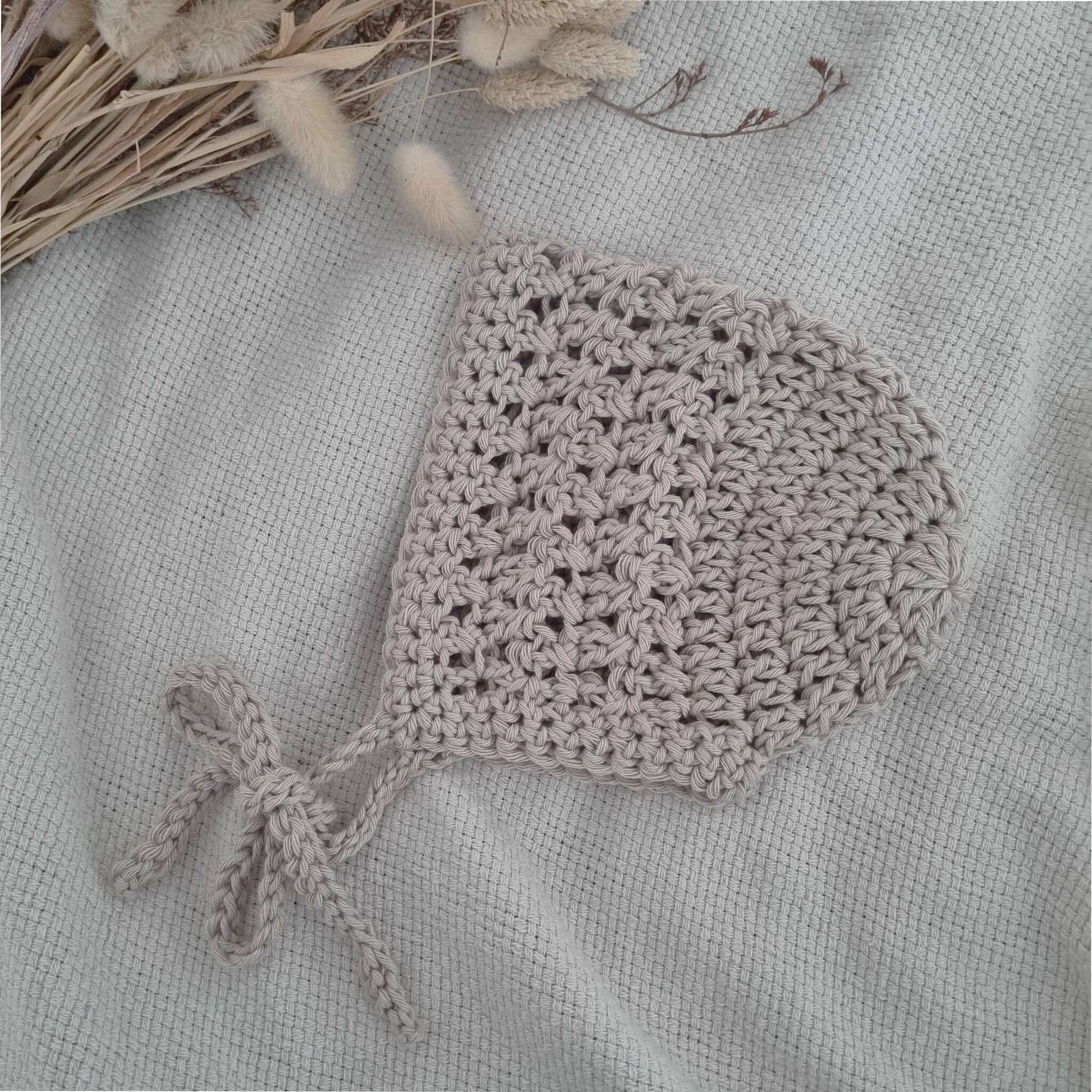 Cute oatmeal crochet baby bonnet, a lovely addition to your baby's wardrobe. Perfect for warmth and style in any season.