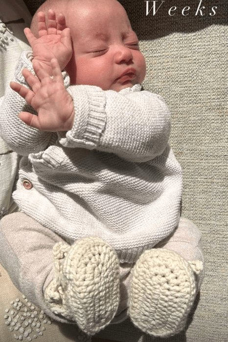 Baby Laced Boots- Cream, featuring a cozy baby in knitted attire with laced boots, exuding warmth and comfort.